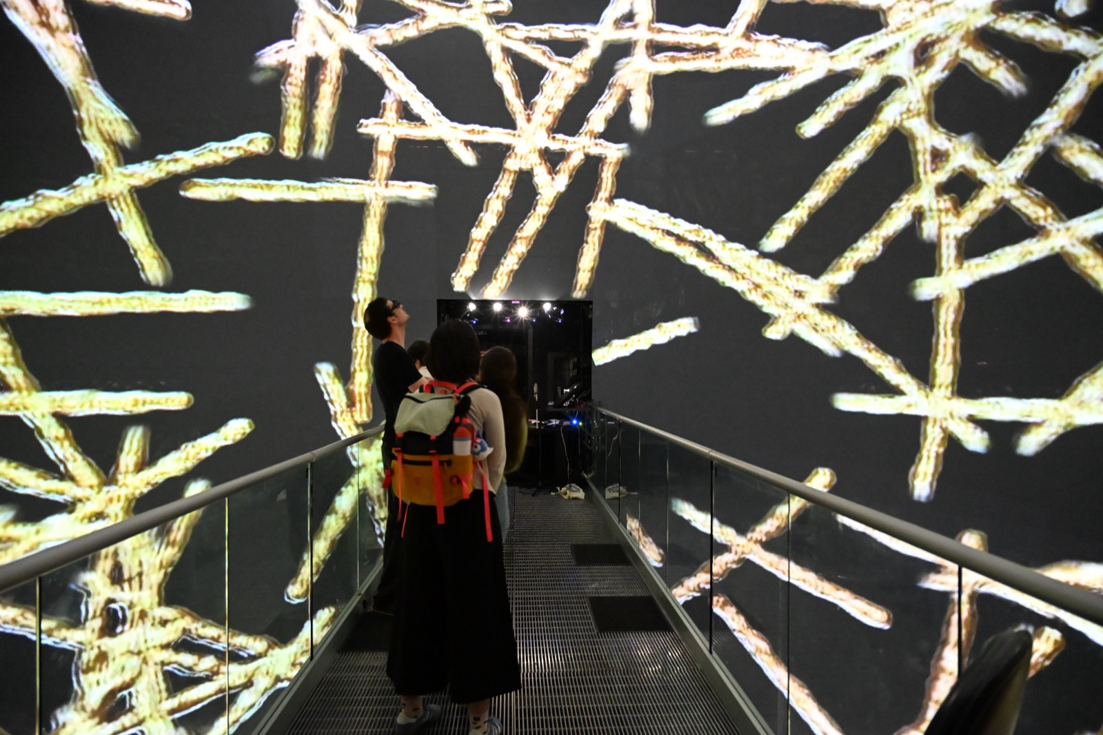 Viewers on the bridge of the AlloSphere surrounded by the Golden Boy projection