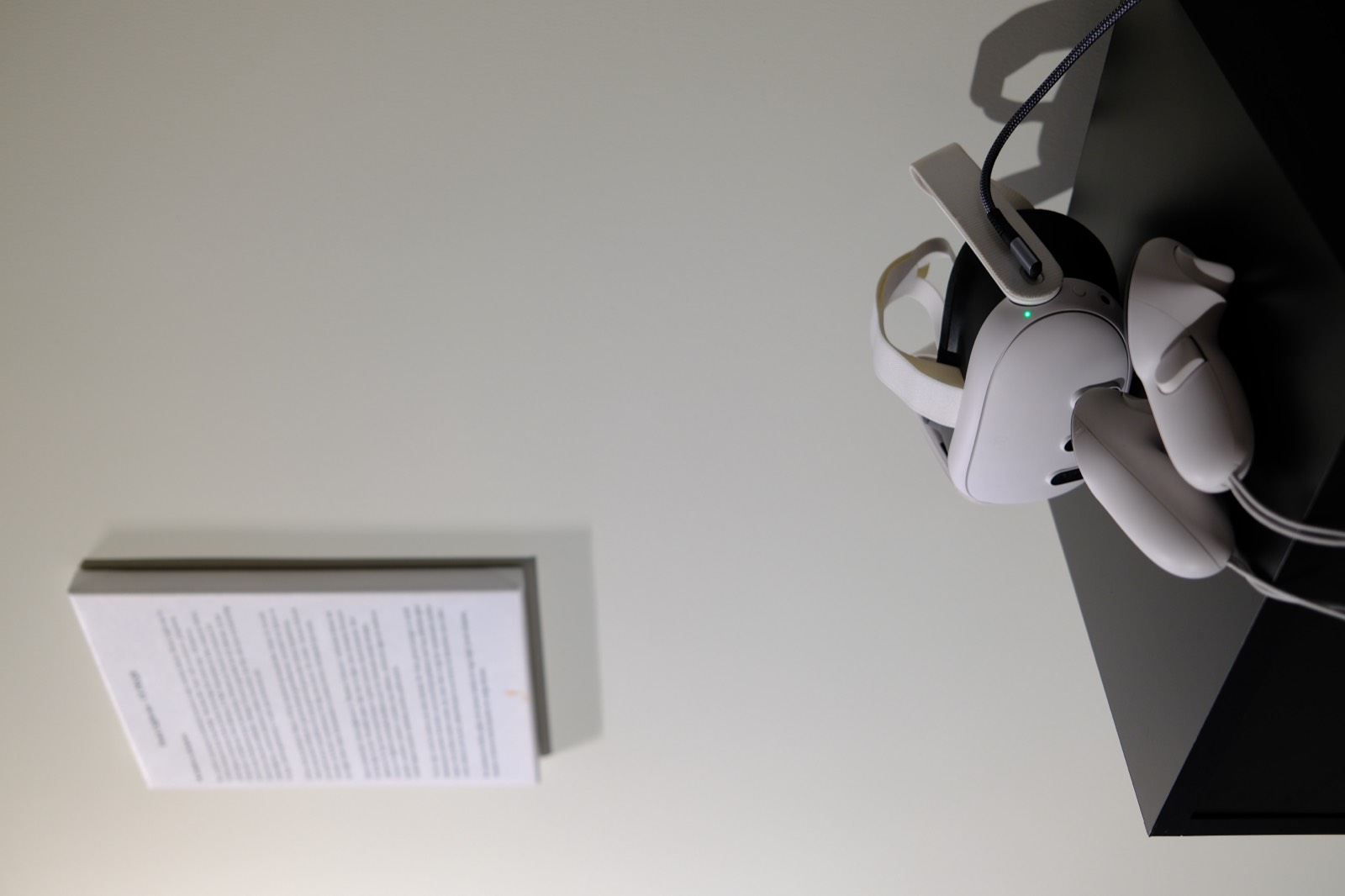 VR headset on a plinth next to the wall text at Loft Art Istanbul